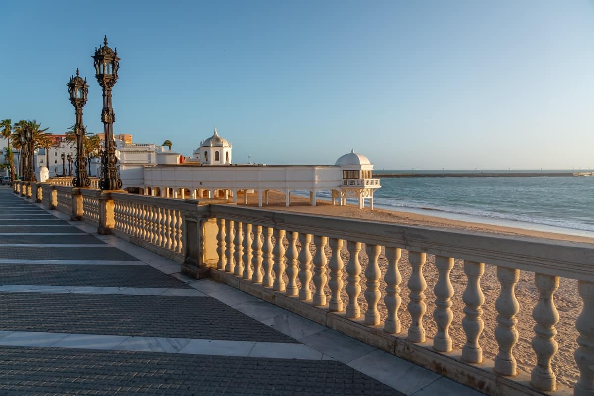 sea, beach and a seaside promenade at the golden hour; La Caleta Beach in Cadiz