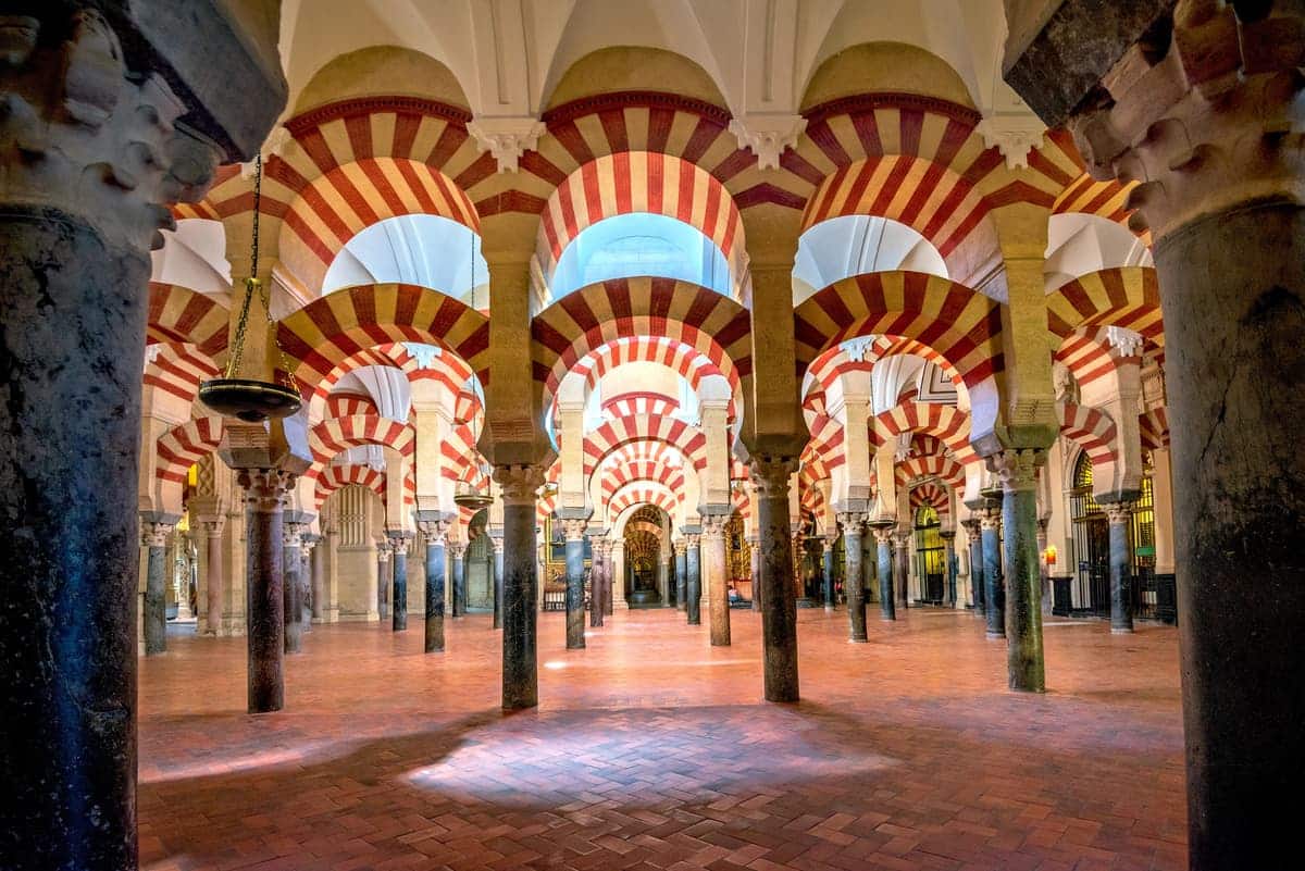 interior of a church with lots of arched columns, a former mosque; The Mosque-Cathedral in Cordoba
